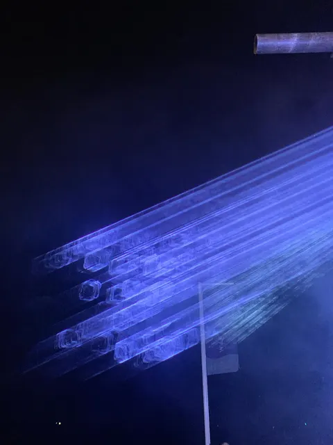 A tunnel of blue laser light through haze
